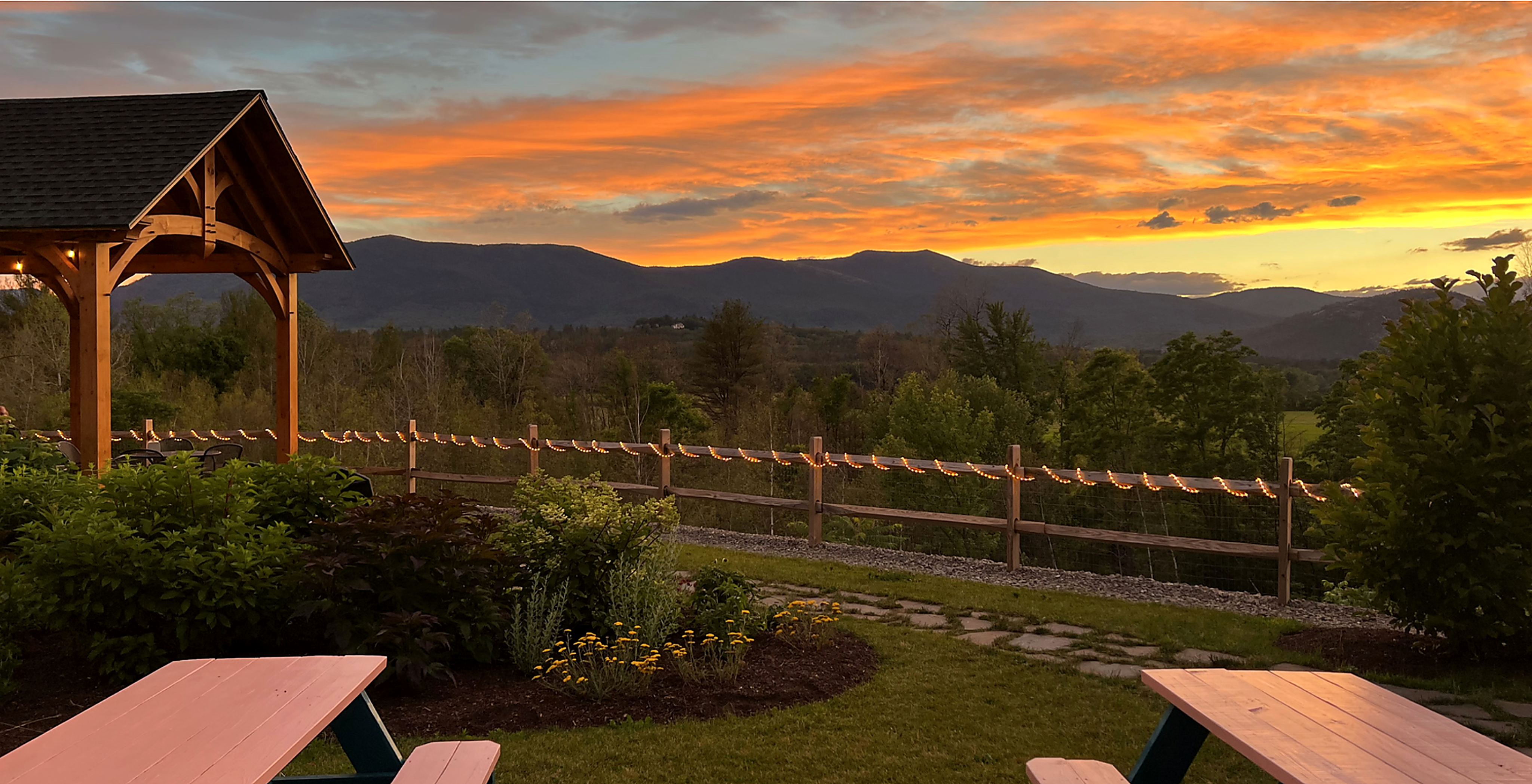 Gazebo overlooking mountain sunset landscape
