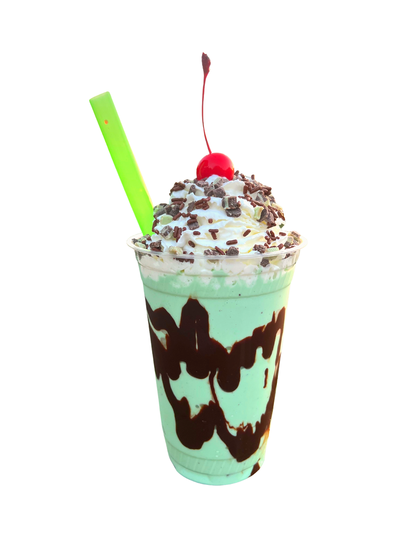 Mint Chocolate Chip Milkshake in a plastic cup with chocolate syrup drizzle, whipped cream, sprinkles, cherry and green straw 