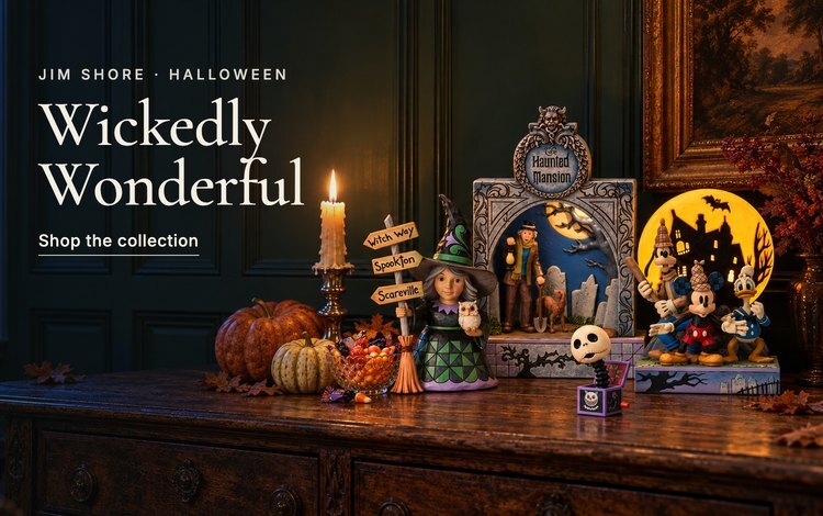 Jim Shore Halloween figurines on a candlelit sideboard