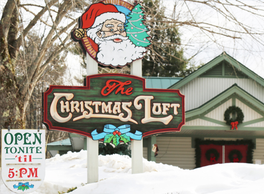 Photo of the exterior of the building and business sign at The Christmas Loft located at 259 Main Street north Woodstock nH 03262