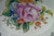 Part of the floral artwork with the tiny signature