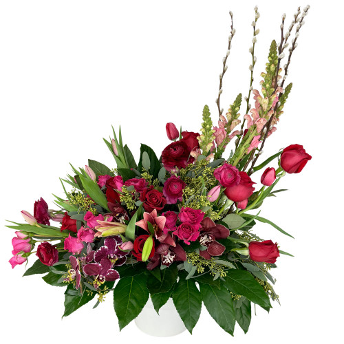 A lush, asymmetric statement piece featuring striking height, dramatic color depth, and dynamic textural elements