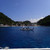 A traditional banca outrigger boat approaching Apo Island, Negros Oriental — one of the Philippines' most established marine sanctuaries and a top spot for diving and snorkelling with sea turtles