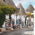 Souvenir shops in front of traditional trulli houses with conical stone roofs on a quiet street in Alberobello, Puglia. Photo by Giulia Gasperini on Unsplash.