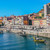 Traditional rabelo boats moored below the colourful riverfront houses of Porto's Ribeira district