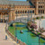 Plaza de España in Seville with a rowing boat on the canal beneath its tiled bridges