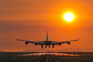 Plane Landing At Sunset