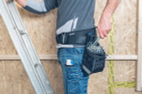 L-BOXX ProClick Nail Pouch, Medium in use on jobsite near with nails