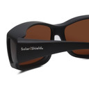 Close Up View of Foster Grant Solar Shield Unisex 62mm Fitover Sunglasses Matte Black/Amber Brown