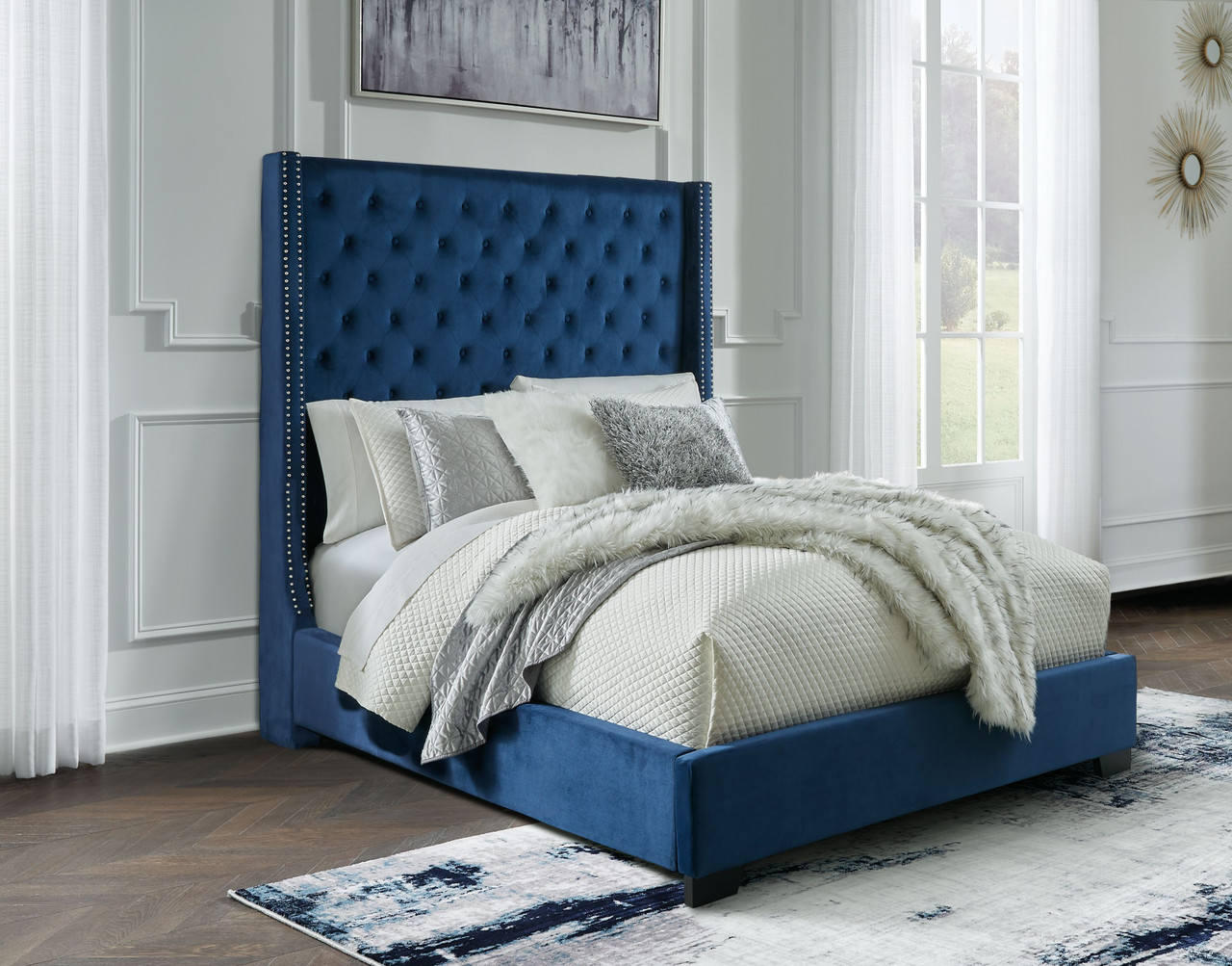 The Coralayne Blue Queen Upholstered Bed is available at Complete