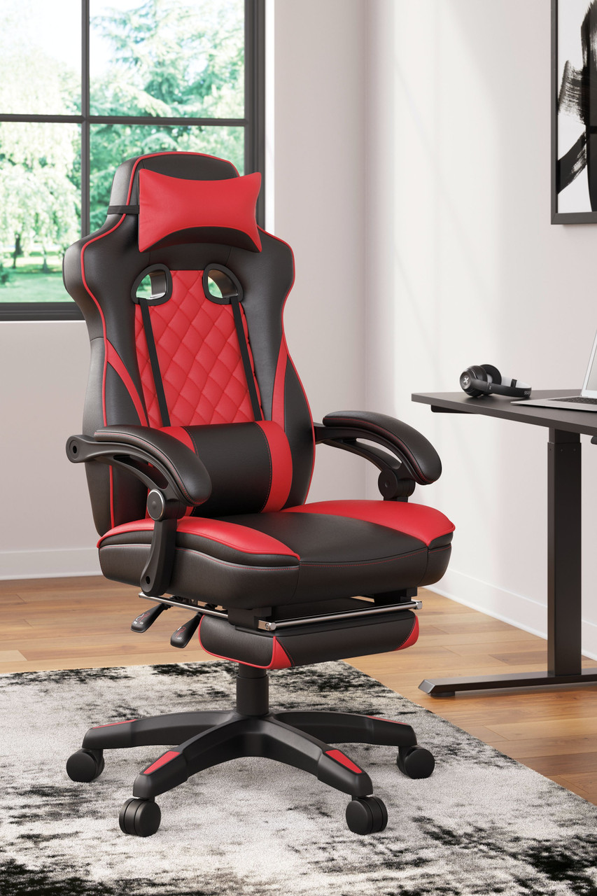 The Lynxtyn Red/Black Home Office Swivel Chair With Pull-out Footrest is available at Complete Suite Furniture, the Northwest.