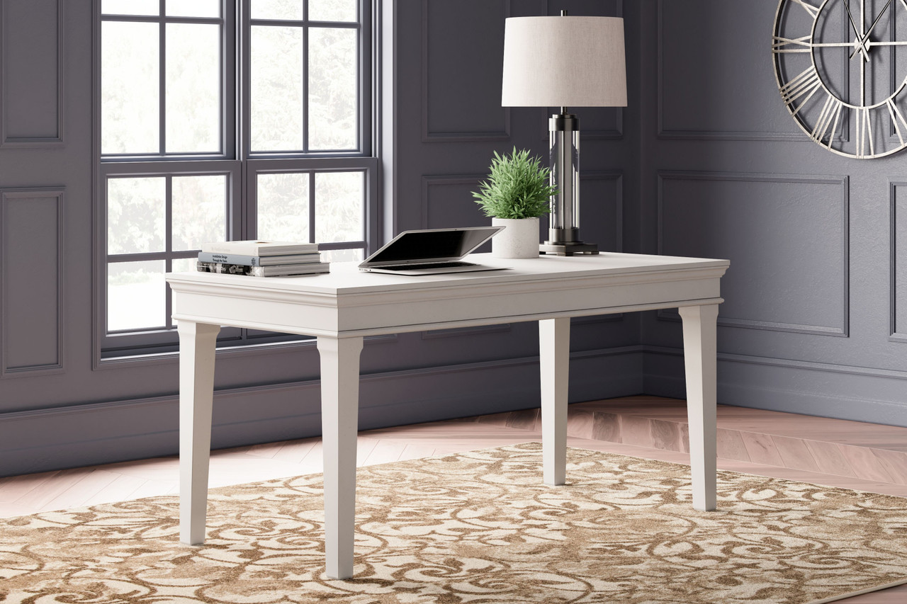 The Kanwyn Whitewash Home Office Storage Leg Desk is available at Complete  Suite Furniture, serving the Pacific Northwest.