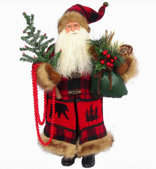 Woodland Santa Claus figurine wearing a red and black buffalo plaid coat with faux fur trim, holding a Christmas tree and green holiday gift sack.