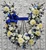 Horseshoe funeral flower tribute with blue & white flowers and greenery