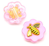 Front (pink coating with gold bee) and back (textured round pattern on the reverse)
