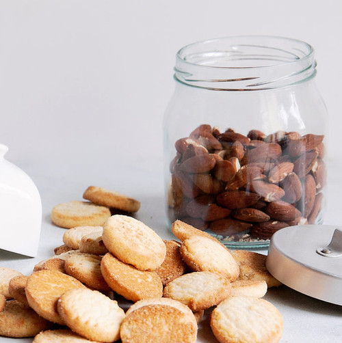 Almond Shortbread Cookies scattered with glass jar of almonds Almond Shortbread Cookies scattered with glass jar of almonds