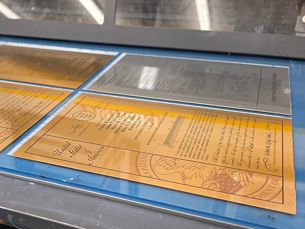 Patent plaques being handcrafted for inventors