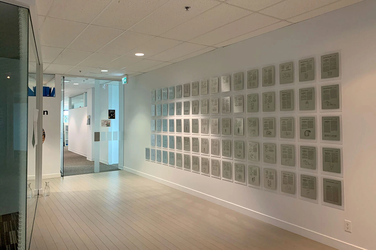 Frosted acrylic patent wall installed in a corporate hallway