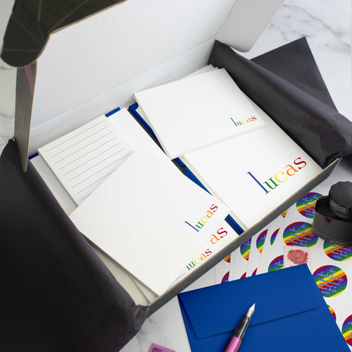 Rainbow personalized stationery gift set in an open box with coordinated notecards, notepads, envelopes, and stickers.