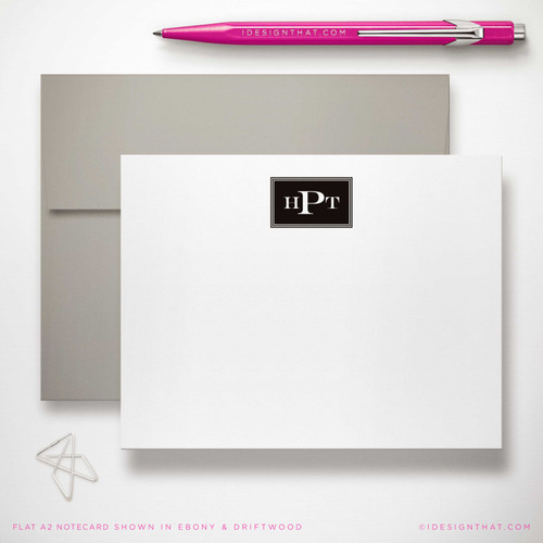 Engraved Monogram flat notecard showing small black block monogram with a gray envelope.