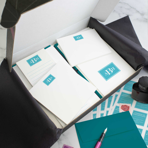 Engraved Monogram personalized stationery gift set in an open box with coordinated notecards, notepads, envelopes, and stickers.