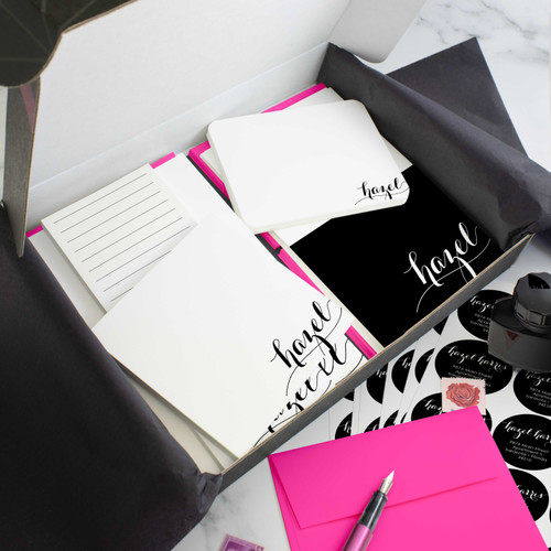 Holla Swash personalized stationery gift set in an open box with coordinated notecards, notepads, envelopes, and stickers.