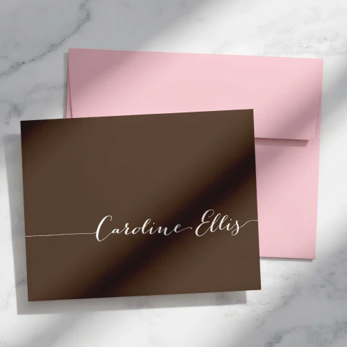 Simple Calligraphy folded notecard showing light script name on a brown card with a pink envelope.