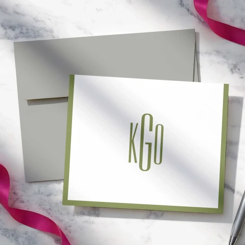 Slim Monogram folded notecard showing slim green monogram and border with a gray envelope.