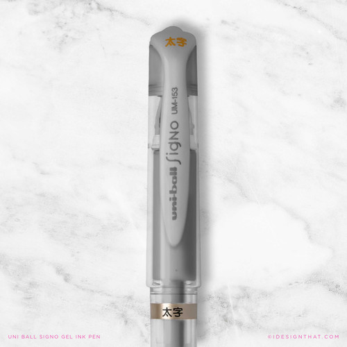 Close-up of a Uni-Ball Signo metallic silver ink gel pen with a clear cap.