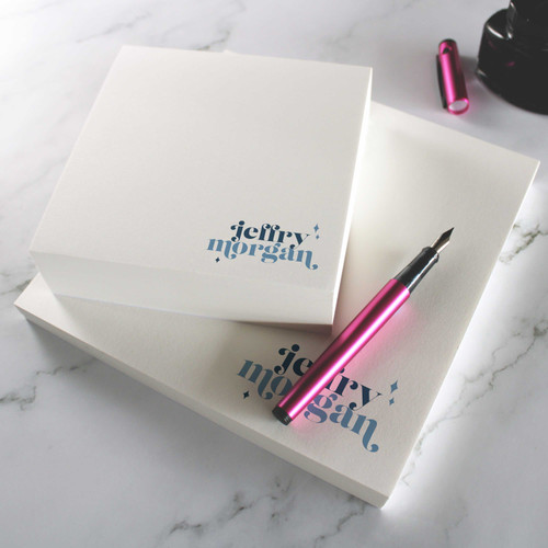 Wild Stardust square notepads with a two-color retro name near the lower corner.