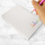 Child writing on rainbow personalized kids notepad—custom name “Dakota” at bottom corner