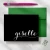 Holla Swash folded notecard with white Giselle calligraphy on a black front, green envelope, pink pen and geometric paper clip.