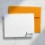 White Holla Swash flat notecard with rounded corners and black Fiona script in the lower-right corner, shown with an orange envelope on marble.