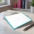 Angled close-up of a Modern Border folded notecard showing the turquoise border, fold, and softly textured eggshell cardstock.