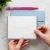 Modern Border personalized folded notecard held in two hands to show the card’s scale, with a pale blue envelope behind it.