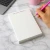Personalized rectangular notepad demonstrating a full name with suffix while a handwritten note is being started on the page.