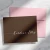 Simple Calligraphy folded notecard showing light script name on a brown card with a pink envelope.