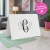 Traditional Script folded monogram notecard standing open with a black and mint three-initial design and coordinating mint envelope.