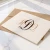 Ivory Traditional Script folded notecard with a brown and tan three-initial monogram and coordinating neutral A2 envelope.