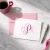 Personalized Traditional Script folded stationery card with a pink three-initial monogram, coordinating pink envelope, and silver pen.