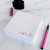 Writing demo on a square rainbow notepad for kids—showcasing personalized stationery.