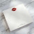 Closeup of Romantic Kiss square notepad featuring bold red lips and personalized name; luxe stationery for women.