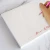 Handwriting on a personalized square notepad with the name printed along the bottom