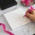 Square personalized notepad with writing space on a bright desk