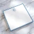 Blue-bordered personalized square notepad with blue monogram on marble