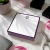 Purple-bordered personalized square notepad with monogram, scissors, and desk styling