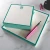 Teal-bordered personalized square notepads with green monograms and pink pen