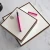 Brown-bordered personalized square notepads with monograms and pink pen