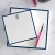 Navy-bordered personalized square notepads with monograms and pink pen