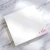 Angled view of a Holla Swash square notepad with a hot-pink script name, showing the paper stack and open unlined writing area.